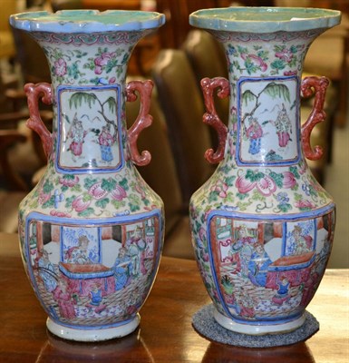 Lot 498 - A pair of 19th century Canton porcelain twin handled vases, of baluster form, reserves...