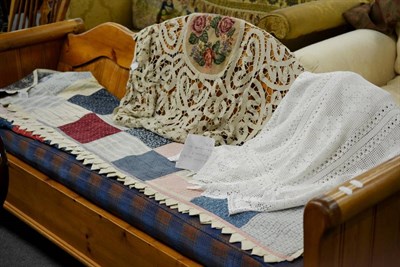 Lot 511 - A Victorian patchwork quilt, crochet bed cover and table throw with woolwork centre and crochet...