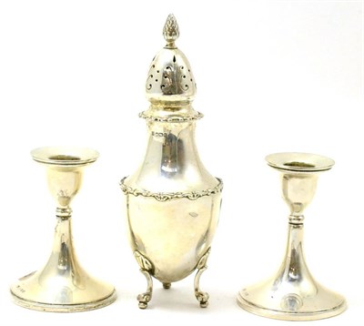 Lot 525 - A silver sugar caster and a pair of silver loaded dwarf candlesticks