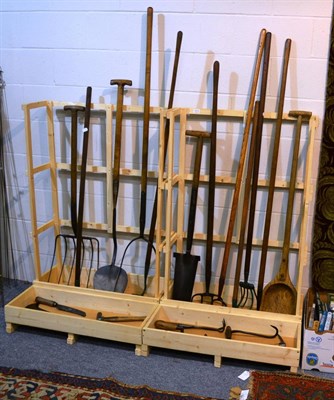 Lot 1014 - A group of vintage farming implements including hand scythes, hatchets, pitch forks, etc