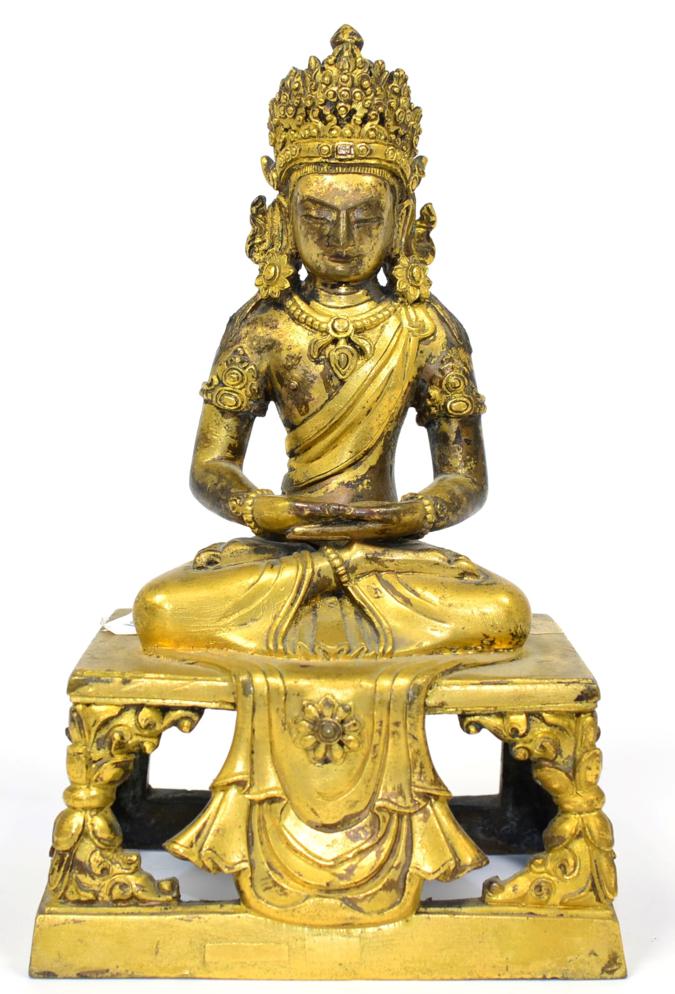 Lot 148 - A Gilt Bronze Figure of  Buddha, probably Tibet, 17th century, seated with headdress and loose...