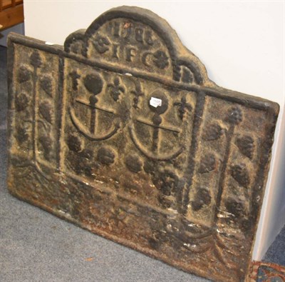 Lot 1107 - A cast iron fireback, rectangular with a domed top, dated, decorated with two anchors and...