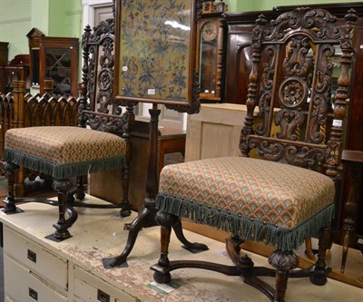 Lot 1132 - A pair of carved oak chairs in the Flemish style