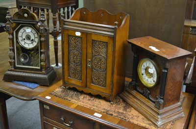 Lot 1138 - An oak smoker's cabinet and two shelf clocks