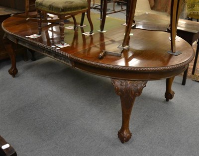 Lot 1144 - A mahogany oblong telescopic dining table on cabriole legs, with winding handle