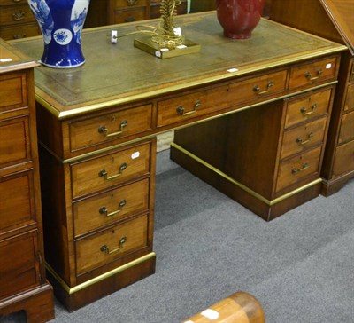 Lot 1158 - A Regency style rosewood pedestal desk with brass bound edges and angular handles