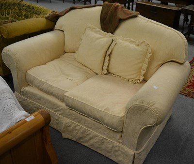 Lot 1161 - A two seater settee with loose pale yellow upholstery