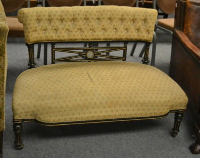 Lot 1175 - Small Victorian settee with ebonised and parcel gilt frame