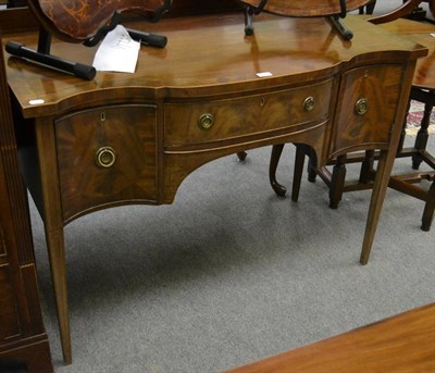 Lot 1195 - A George III serpentine fronted sideboard