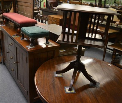 Lot 1214 - An Edwardian mahogany revolving bookcase on quadruped base, a Victorian mahogany long footstool and