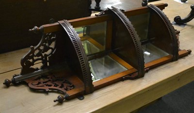 Lot 1221 - A Victorian fret cut walnut corner wall shelf with mirrored panels