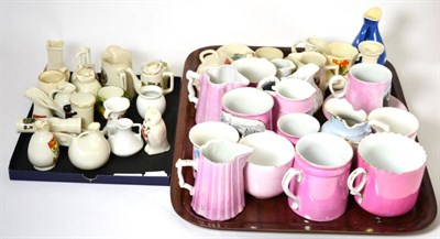 Lot 147 - A quantity of German pink travel memorabilia ware, crested wares and an Adam's vase (on two trays)