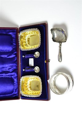 Lot 214 - A cased pair of silver salts, silver caddy spoon and a napkin ring