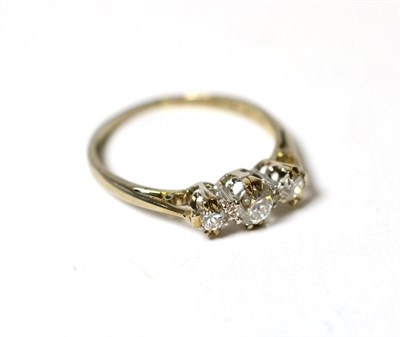 Lot 216 - A diamond three stone ring on an 18ct gold and platinum band