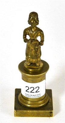 Lot 222 - An 18th century gilt reel (coin) holder in the form of a girl holding a hurdy-gurdy standing on...