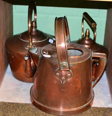 Lot 255 - Two large copper kettles and a jug with carrying handle