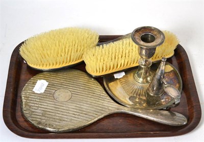 Lot 286 - A silver backed dressing table mirror and two silver backed brushes together with a silver...
