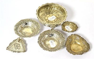 Lot 578 - A Victorian silver bonbon with three lions head legs, four stamped pin dishes and two cherub...