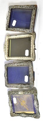 Lot 580 - Three Victorian foliate embossed silver photograph frames and another later example