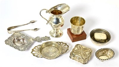 Lot 581 - A silver strainer, a continental white metal strainer, silver sugar nips, a small French silver...