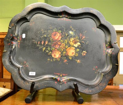 Lot 623 - A Victorian papier mache tray painted with floral sprays