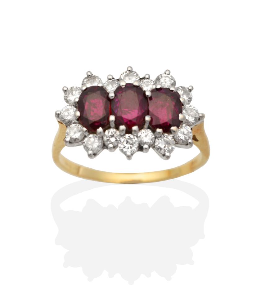 Lot 263 - An 18 Carat Gold Ruby and Diamond Cluster Ring, three oval cut rubies within a border of round...