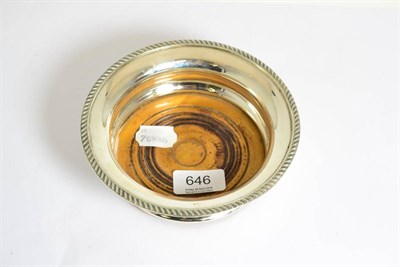 Lot 646 - A silver bottle coaster with turned wooden base, Birmingham 1964
