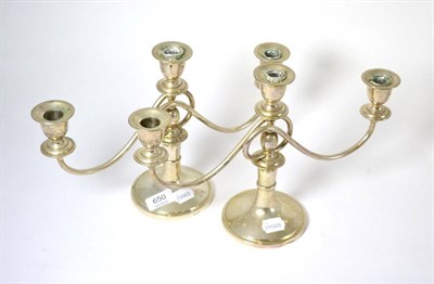 Lot 650 - A pair of Middle Eastern white metal three light candelabra