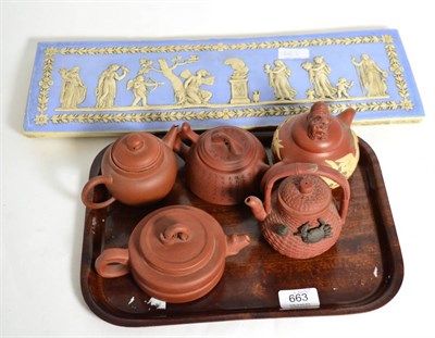 Lot 663 - A reproduction jasperware plaque, together with five Yi Xing teapots