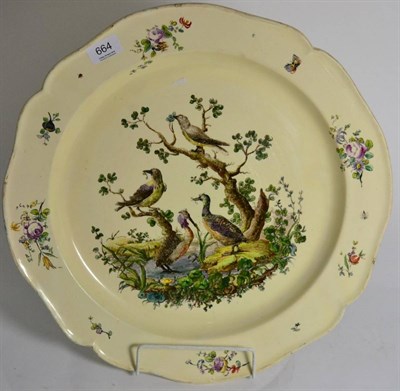 Lot 664 - A Leeds creamware dish, circa 1770, of shaped circular form, painted in colours with exotic...
