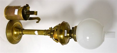 Lot 667 - A 19th century brass columnar oil lamp together with a set of three graduating brass measures
