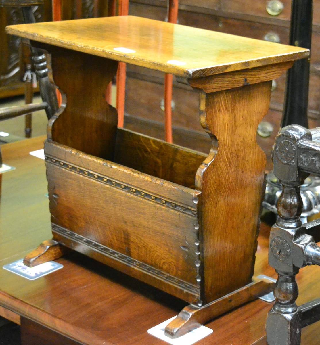 Lot 1453 - An oak magazine rack