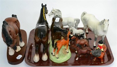 Lot 10 - A collection of Beswick pottery models including dapple grey and brown horses, Freisian calf...