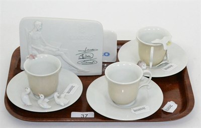 Lot 37 - Five various Lladro pieces including three cups and saucers and two plaques, one signed (5)