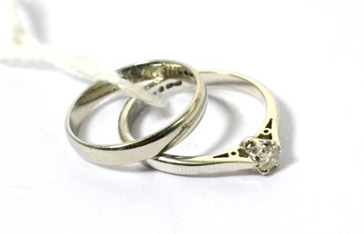 Lot 73 - A solitaire diamond ring and a wedding band (2)
