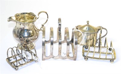Lot 78 - Two silver toast racks, one plated toast rack, cream jug together with a mustard pot with spoon and