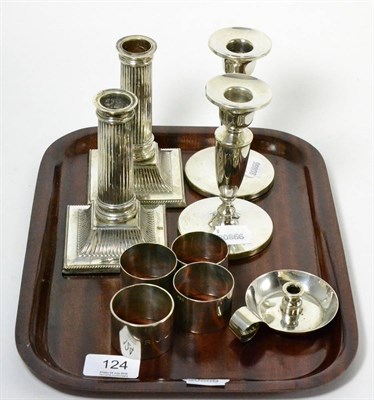 Lot 124 - Two pairs of silver candlesticks, four silver napkin rings and a small Scottish silver chamberstick