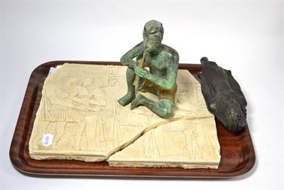 Lot 143 - A carved Egyptian relief plaque (a.f.), an ebonised Egyptian Pharoah figure and a bronze figure...