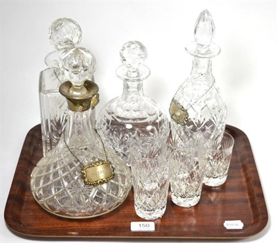 Lot 150 - A group of four decanters including one silver collared example, three silver decanter labels...