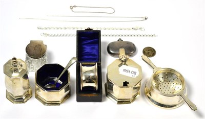 Lot 173 - A small group of silver including a sovereign case, condiments, tea strainer, chains etc