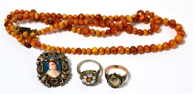 Lot 180 - Amber coloured bead necklace, a Victorian ring stamped 9ct, millefiori ring and a Limoges brooch