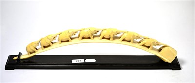 Lot 217 - An early 20th century carved ivory elephant bridge on an ebonised base