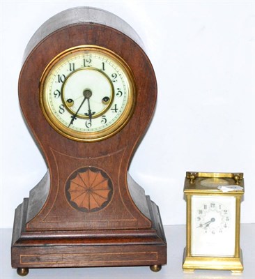 Lot 291 - An Edwardian inlaid mahogany balloon mantel timepiece together with a brass carriage timepiece,...