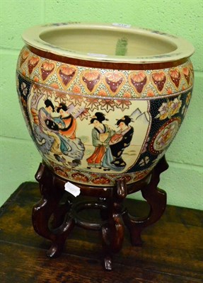 Lot 319 - A pair of 20th Century Satsuma-style carp bowls, on hardwood stands, 31cm in diameter (2)