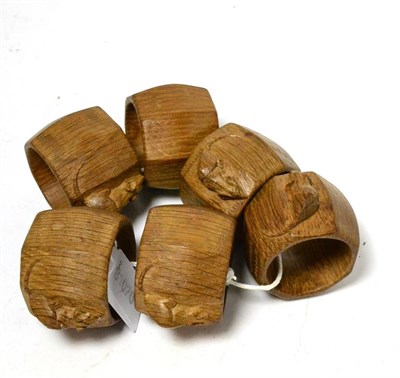 Lot 342 - A set of six Robert ";Mouseman"; Thompson oak napkin rings, each with carved mouse signature, 4cm