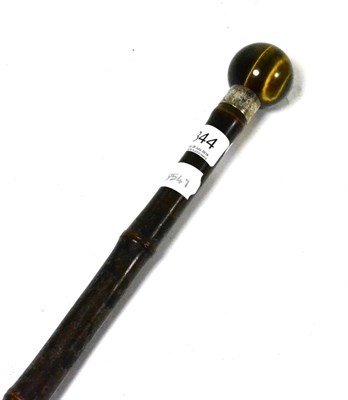 Lot 344 - A Victorian walking cane, tiger's eye pommel, silver collar dated London, 1885 and inscribed...