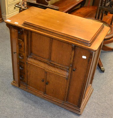 Lot 1078 - An oak wheel barometer, an oak cased Singer treadle sewing machine, a mirror and two stools (5)