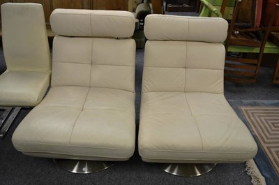 Lot 1135 - A pair of Italian leather and chrome swivel chairs