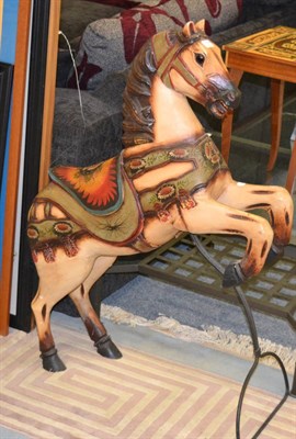 Lot 1137 - A painted and carved wooden carousel horse, on stand, 99cm in height; together with a Swiss musical