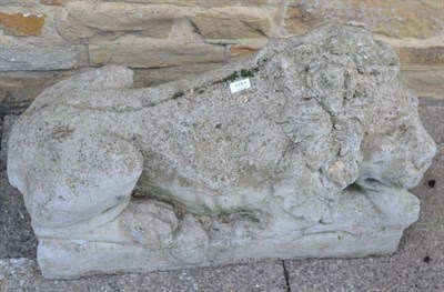 Lot 1151 - A composition stone recumbent lion